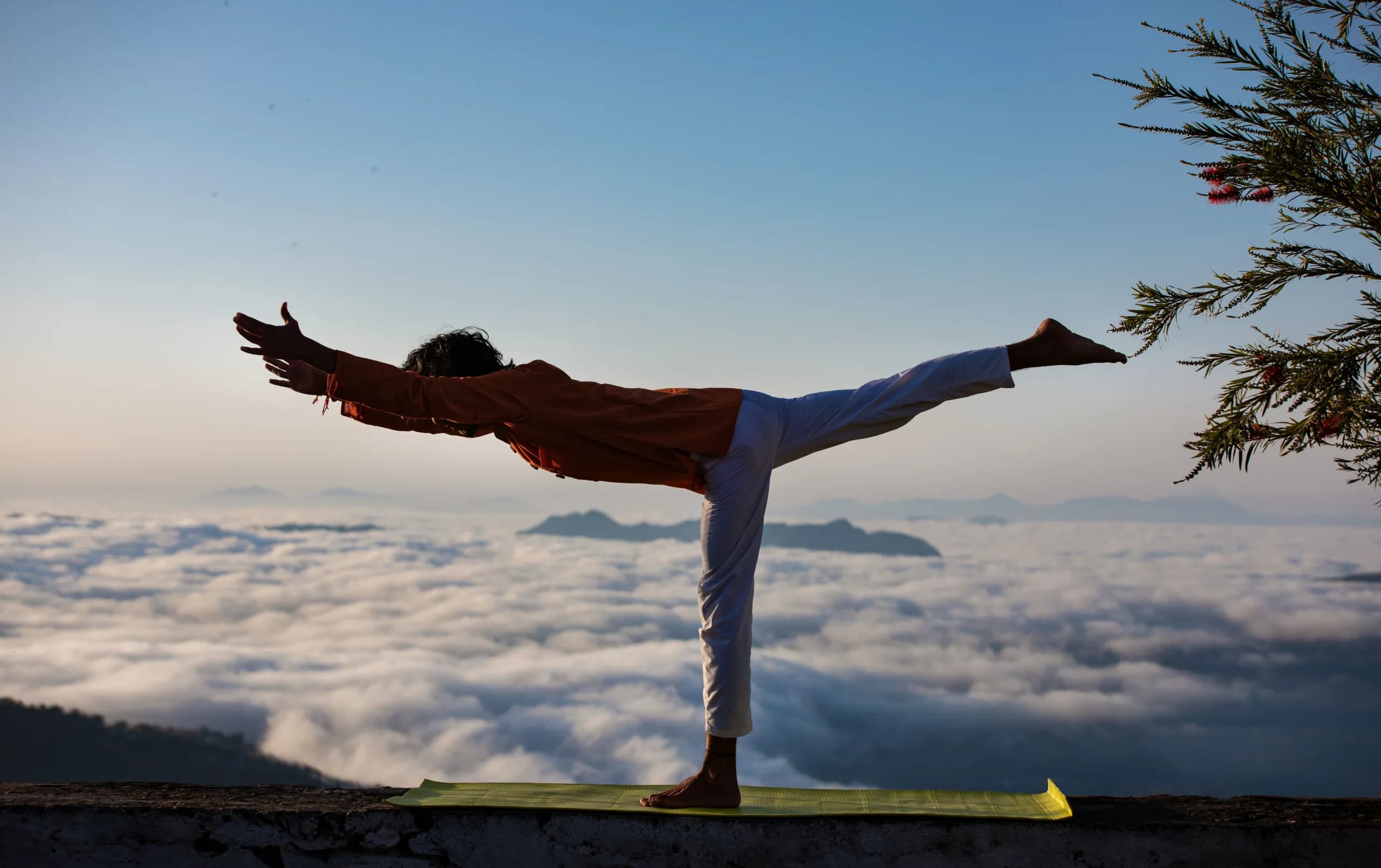Practising yoga on a ridge above the clouds